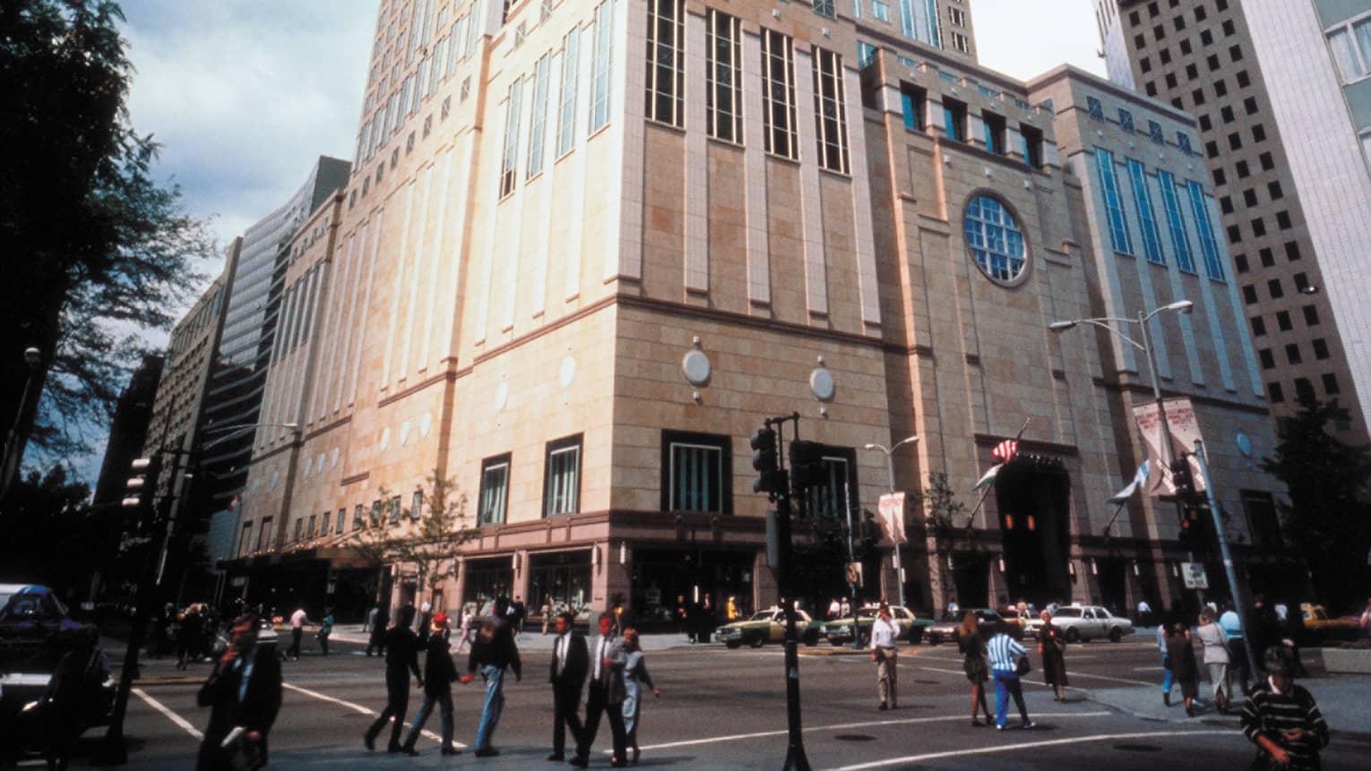 Historic 1980s photo of Four Seasons Hotel exterior, pedestrians on street