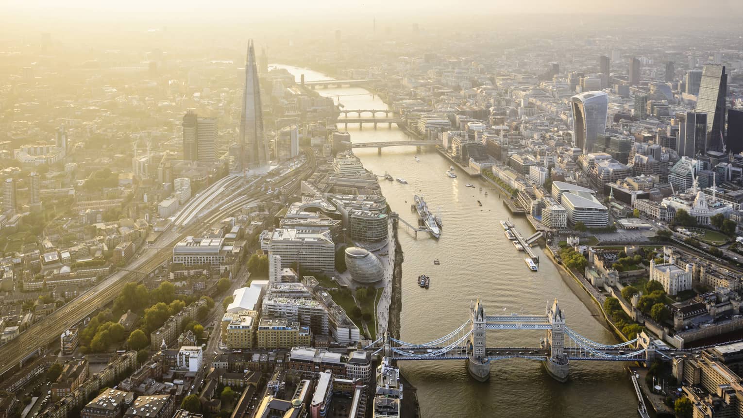 Aerial view of London city buildings along River Thames, London bridge in foreground