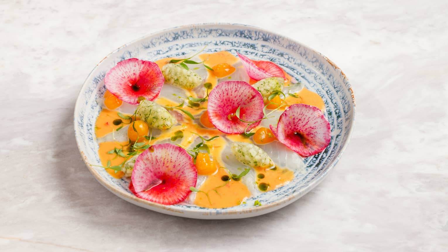 Lubina Carpaccio with peach dressing, basil oil, apple relish, passion fruit, cilantro