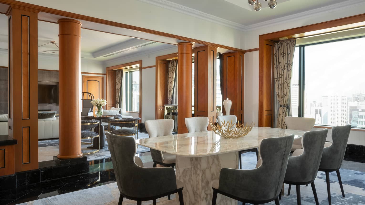 Presidential suite dining area with marble table and floor-to-ceiling windows