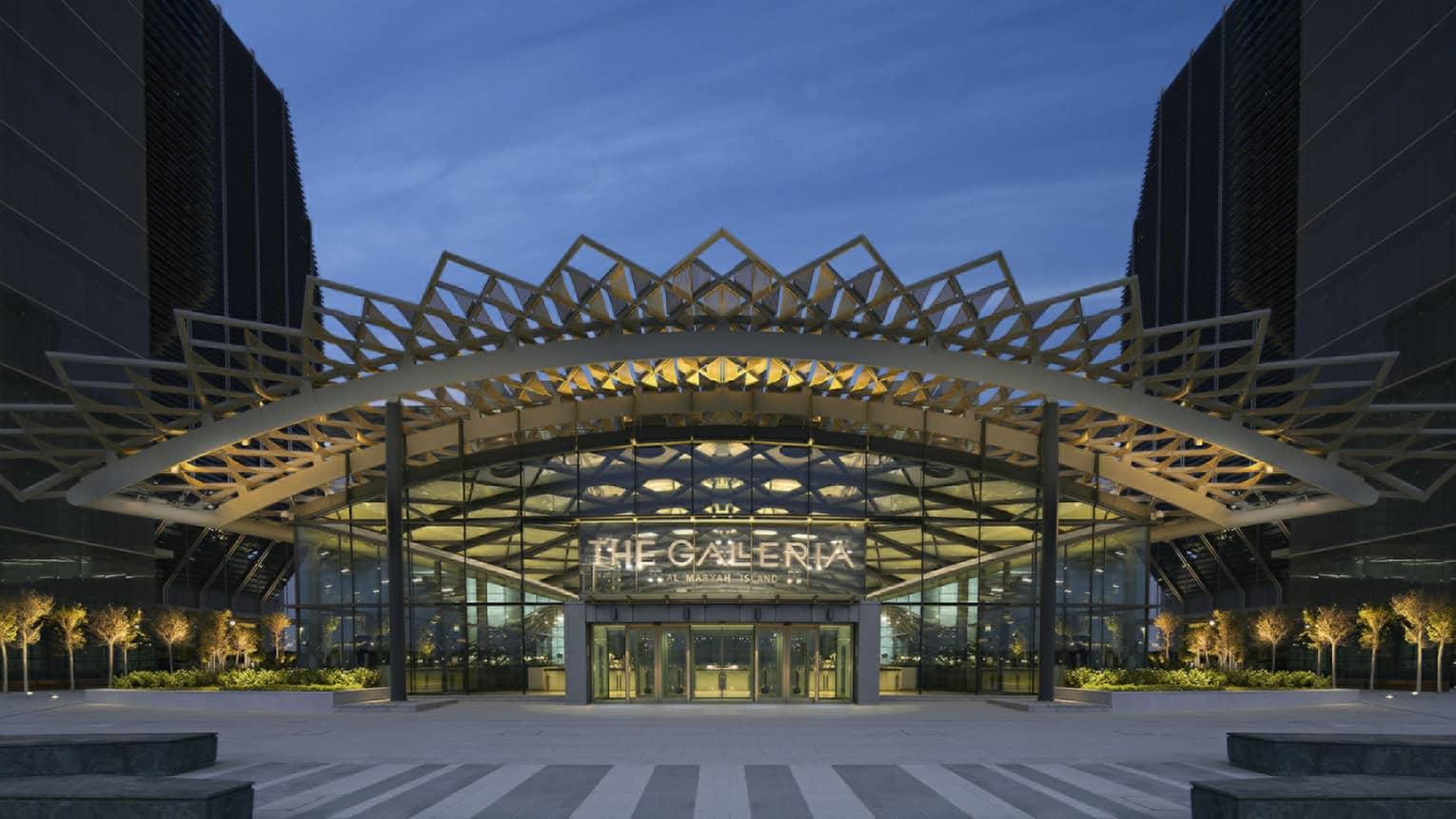 Galleria Mall entrance with sign and exterior with elaborate modern awning at dusk
