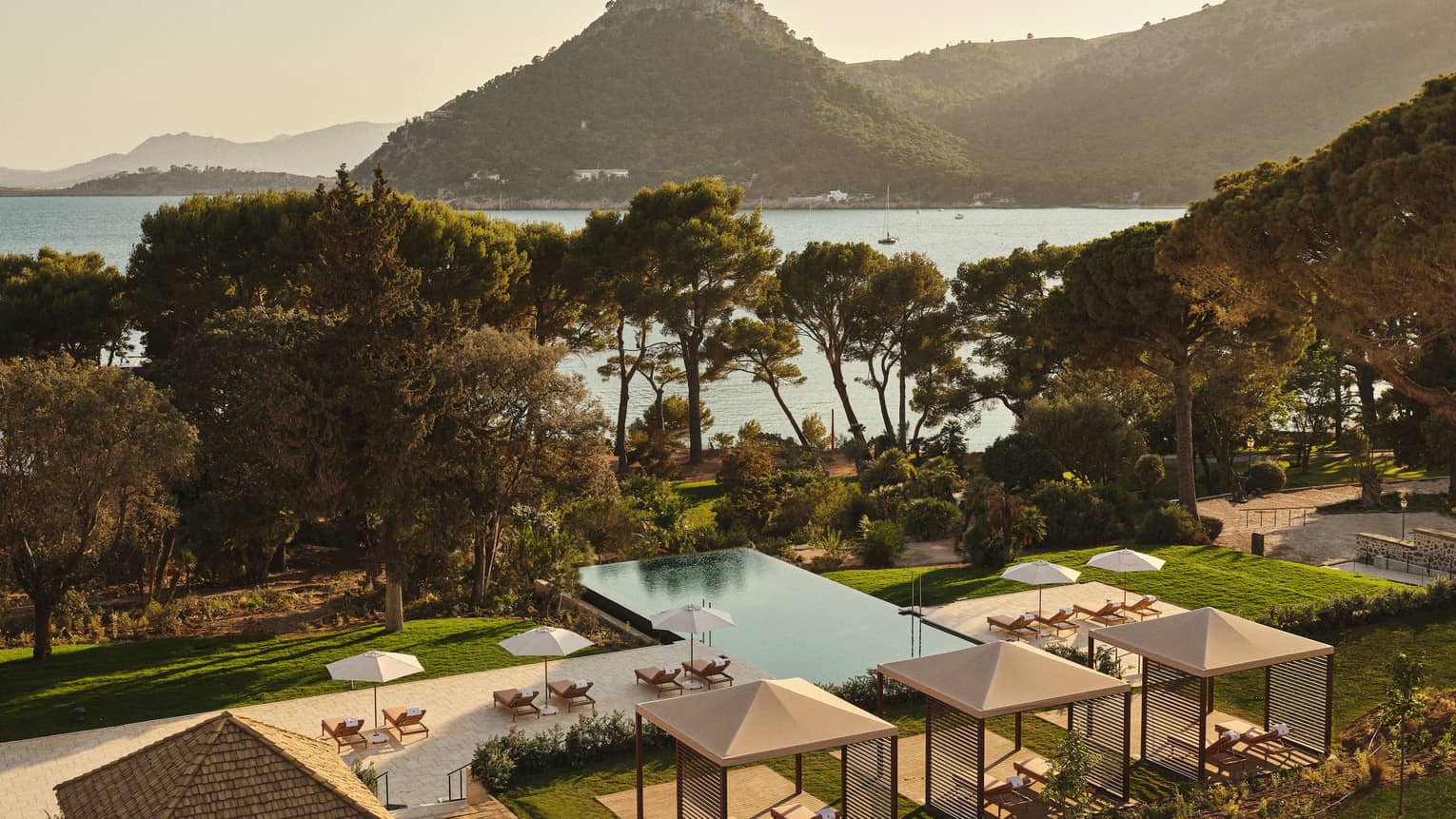 View of pool and ocean/mountain in background