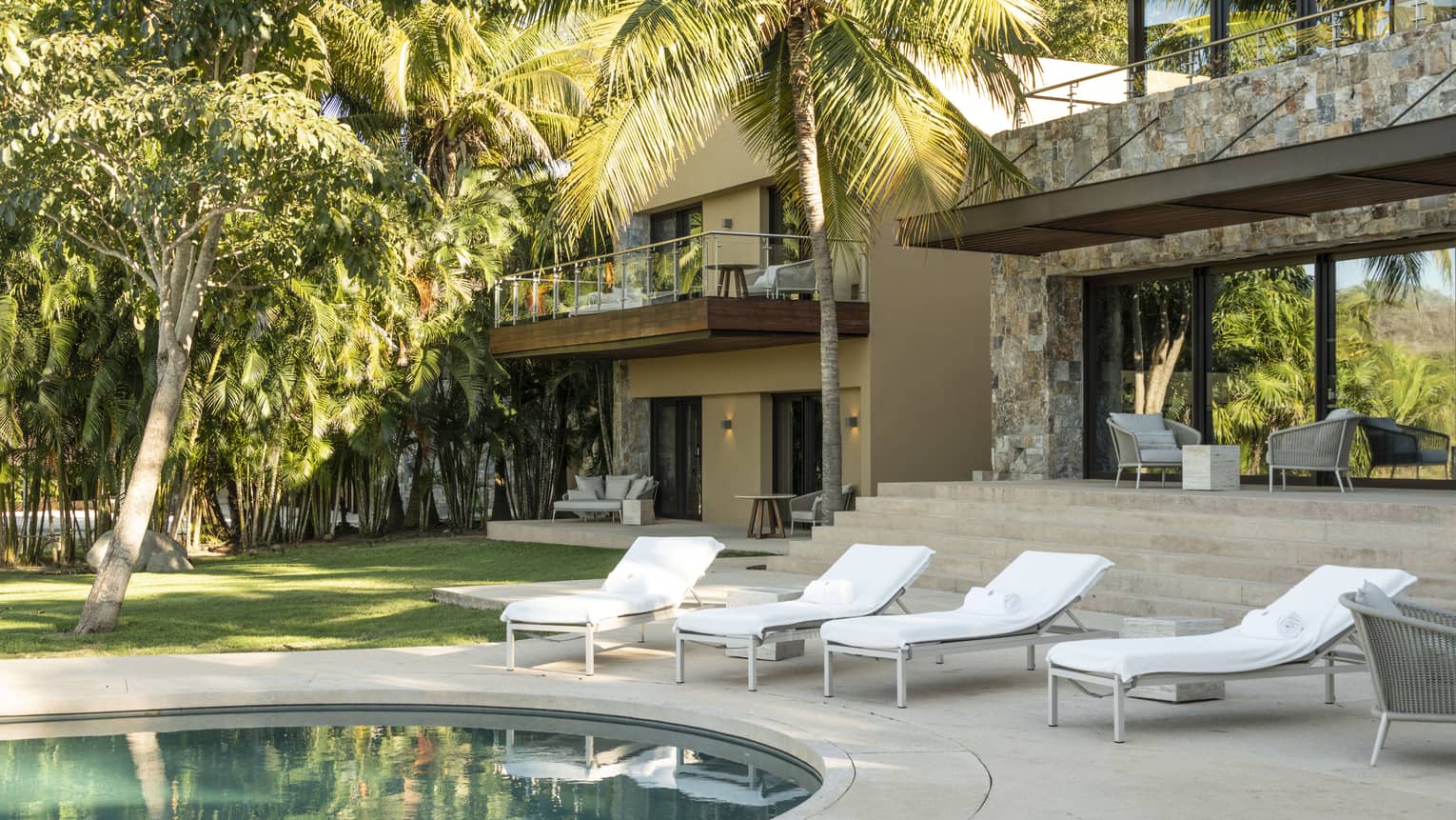 Private residence at Four Seasons Resort Tamarindo pool terrace with four lounge chairs
