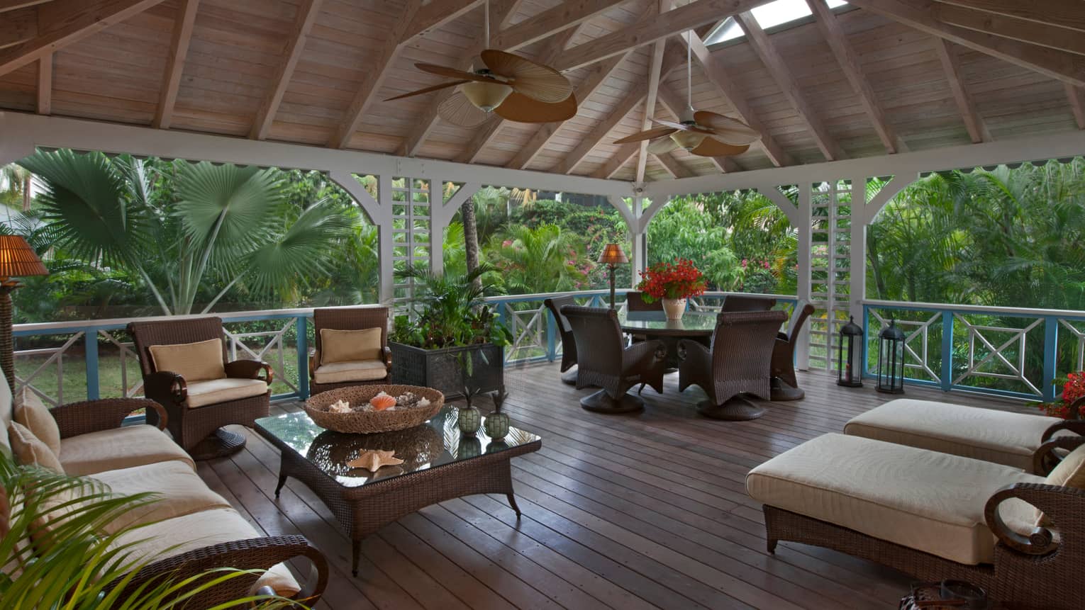 Palm Grove Residence patio, wicker furniture under soaring wood ceilings, fans