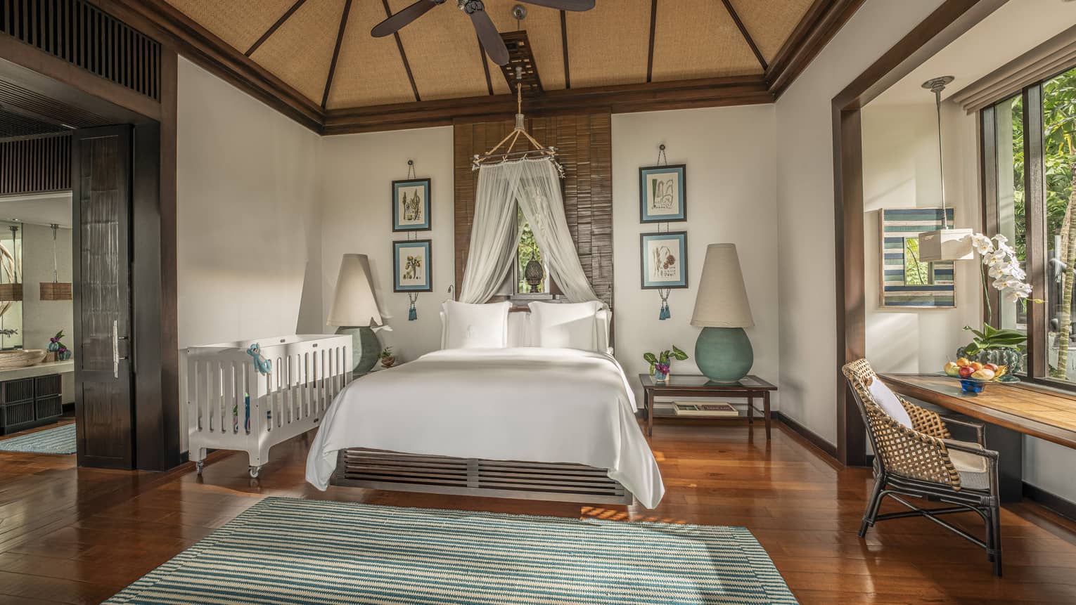 Bedroom with king bed, tent canopy, and crib