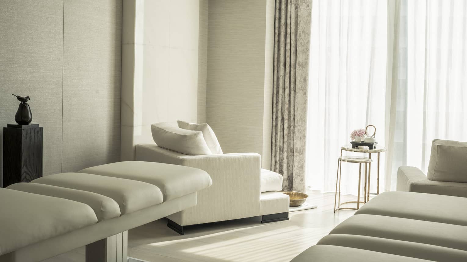 Spa treatment room at Four Seasons Hotel Kuala Lumpur with natural light coming in through windows