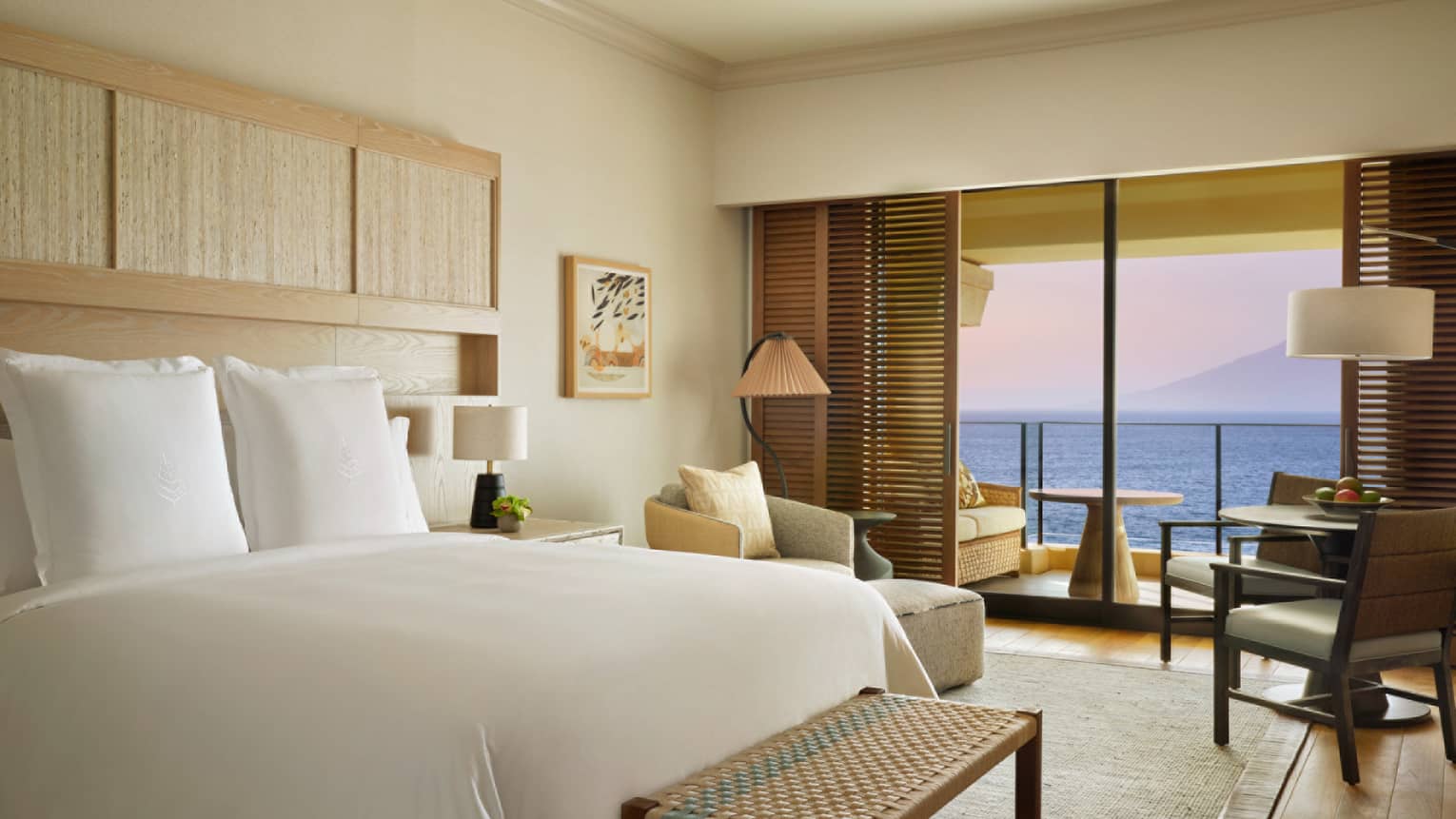 Contemporary resort room with king bed and ocean-view balcony