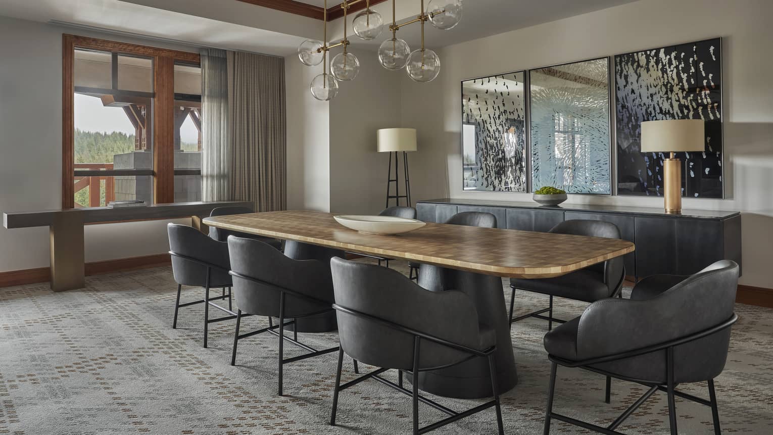 Dining table with eight modern grey seats and a glass pendant lighting fixture