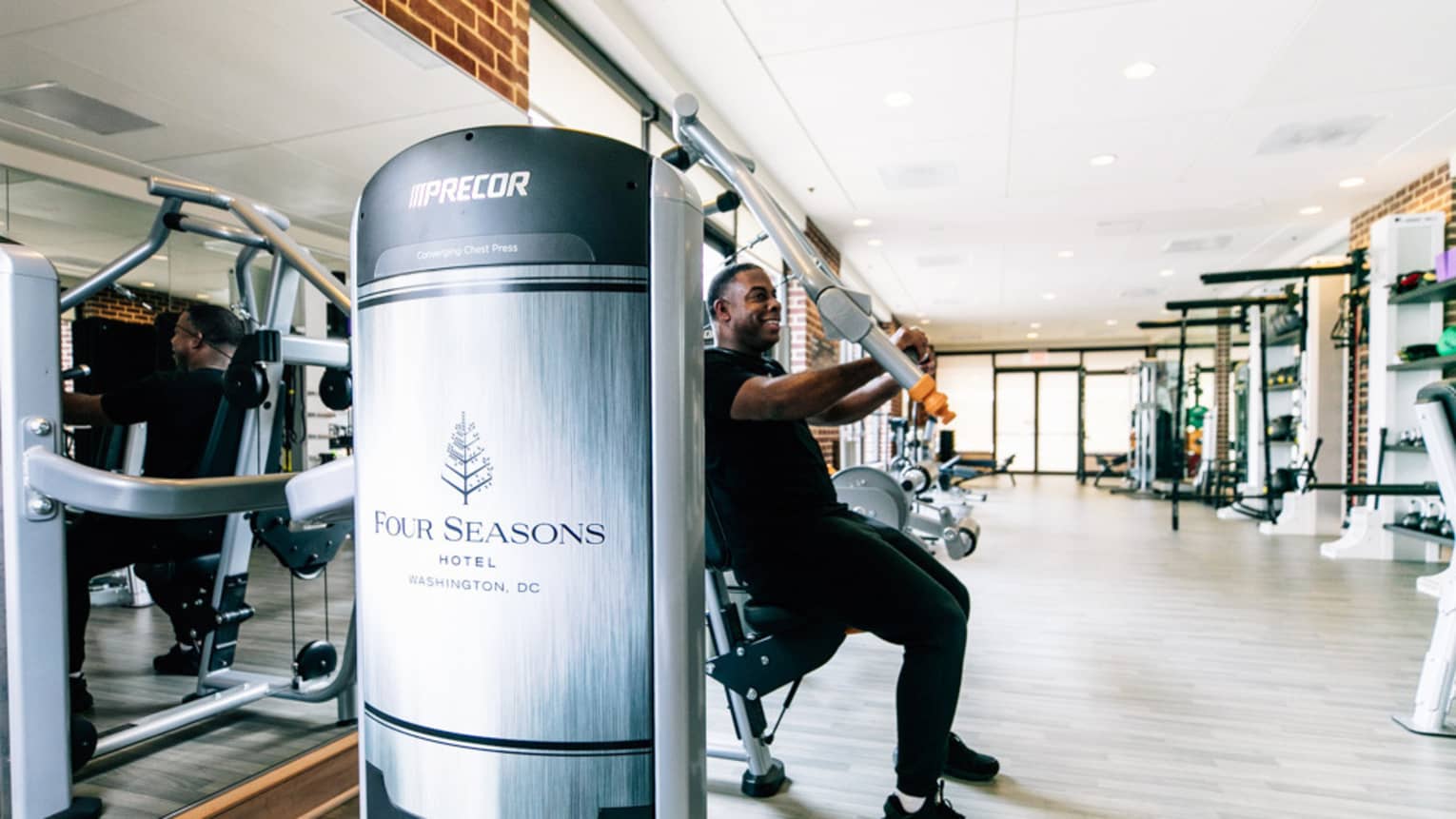 A man uses an arm press at the Four Seasons gym