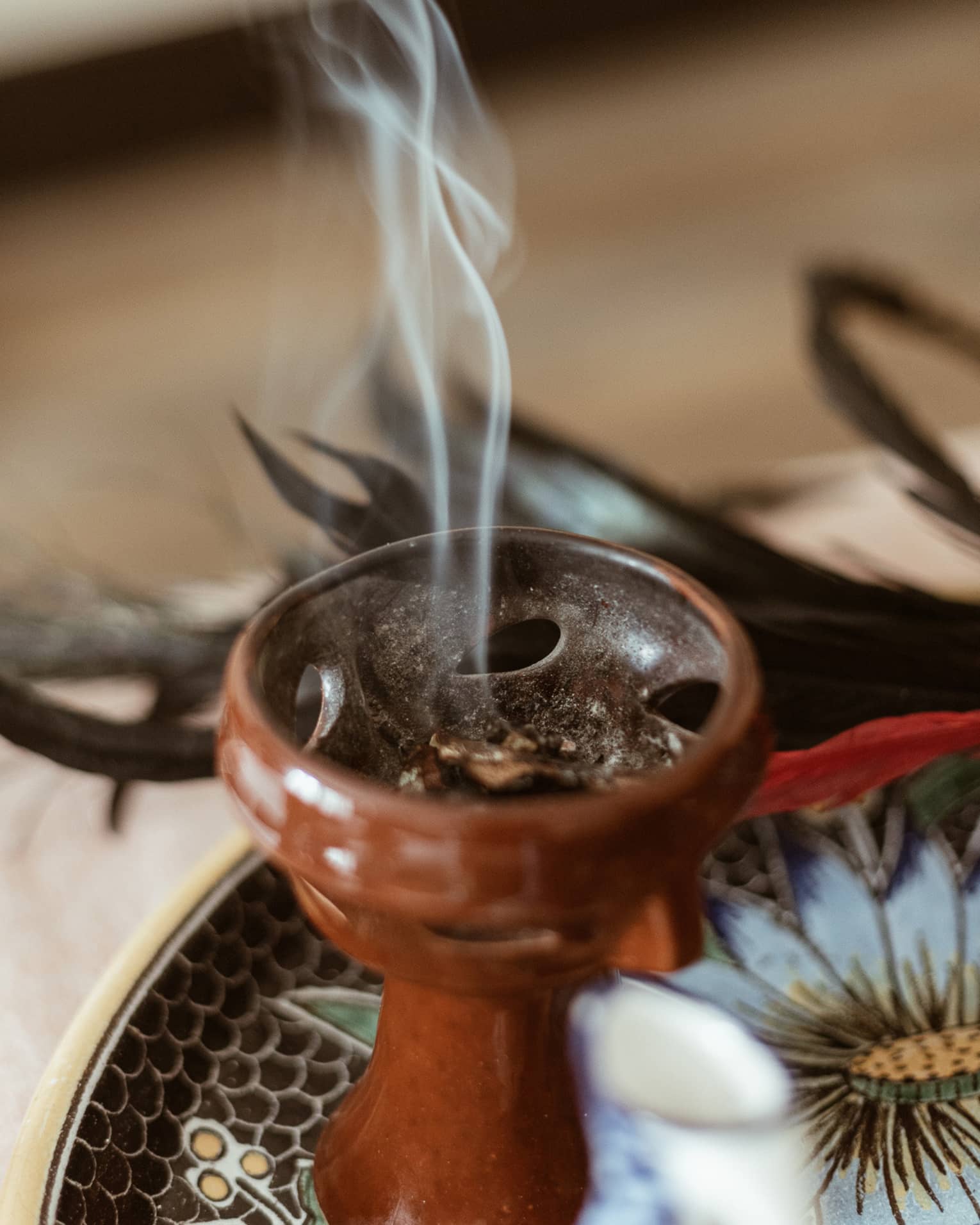 Incense burning in a small brown bowl.