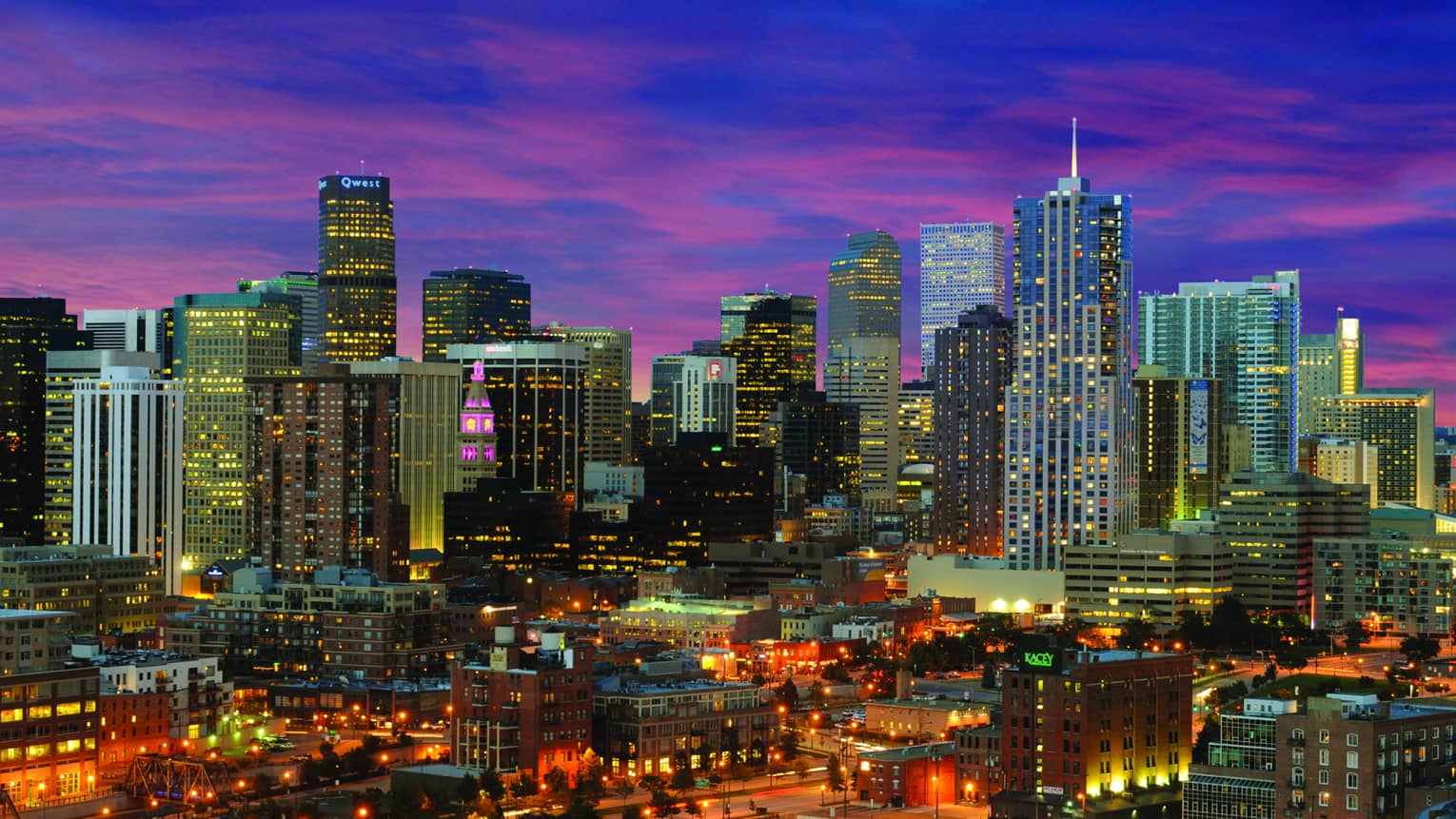 Aerial view of Denver skyline skyscrapers, highways, city lights at night