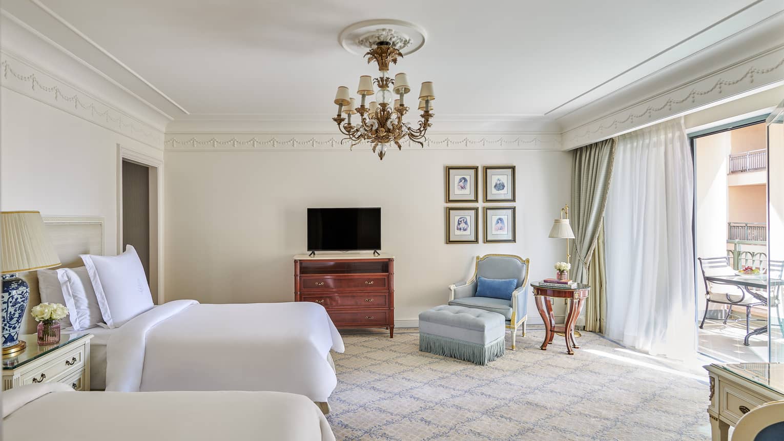 City View Room with two full-size beds, armchair and ottoman, sliding glass door to veranda