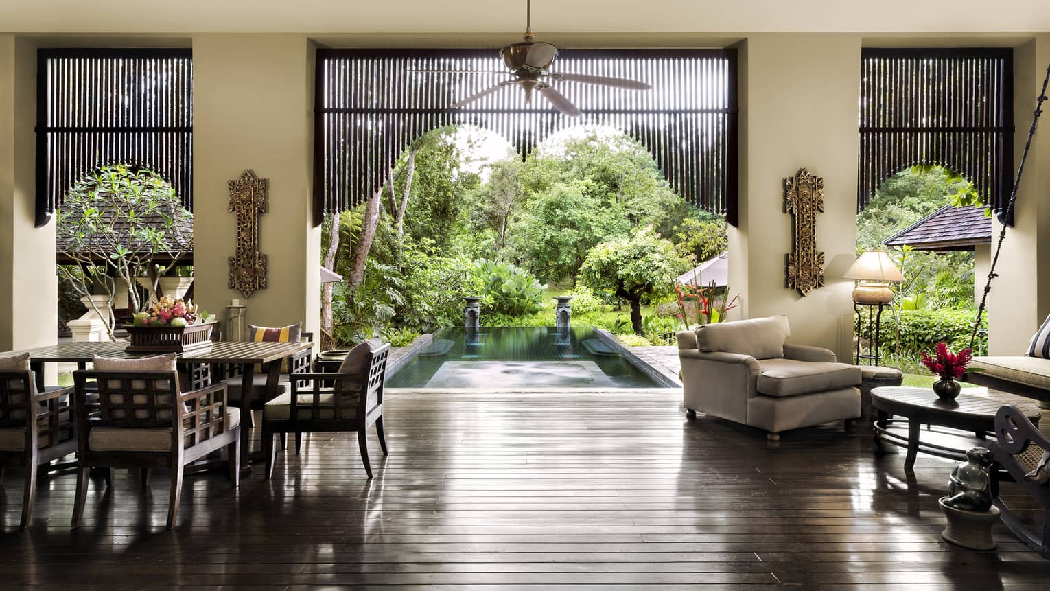 Residence Villa open air living dining room, gleaming wood floors, open wall to pool