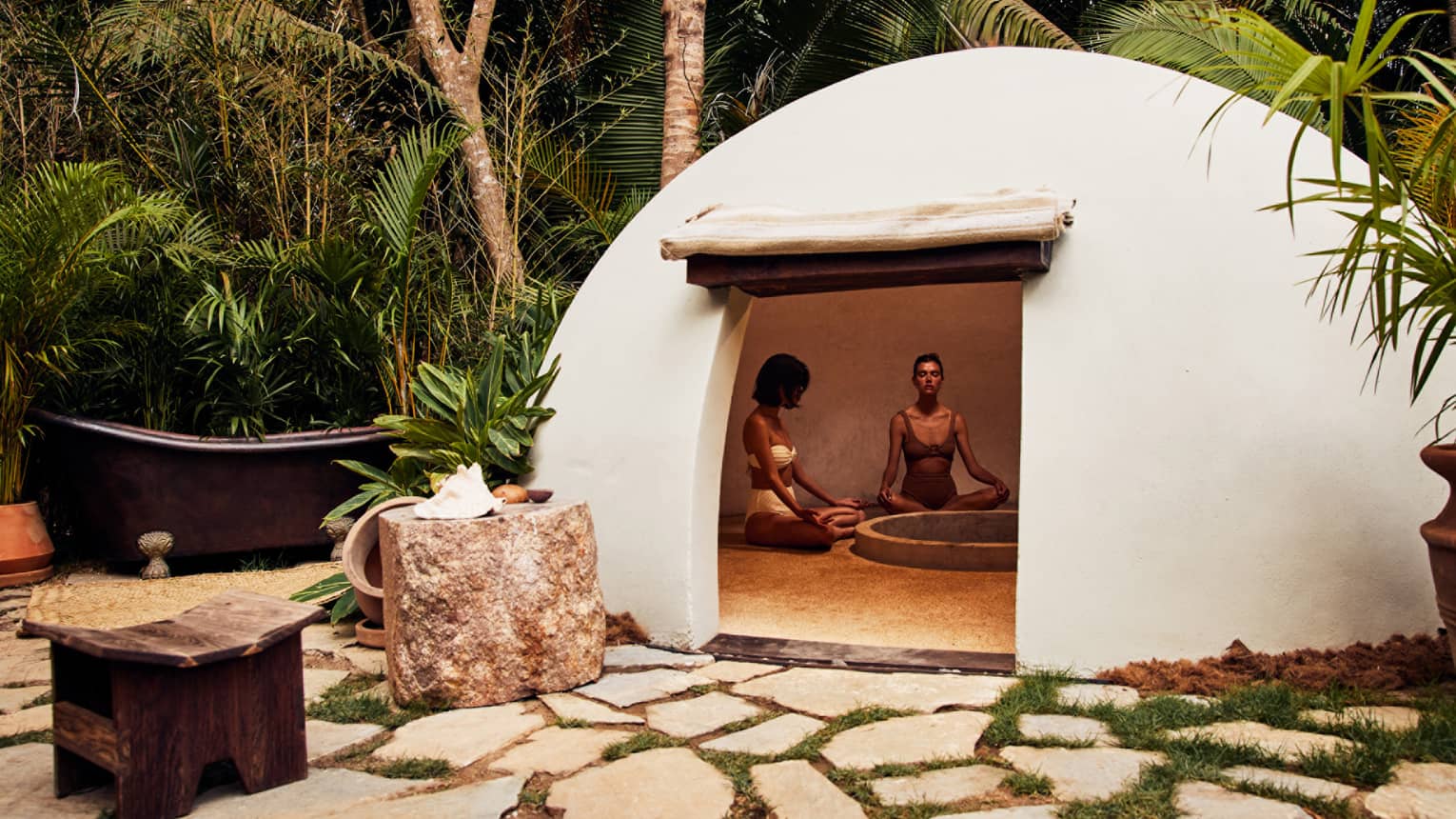 A heated dome shaped room surrounded by trees.