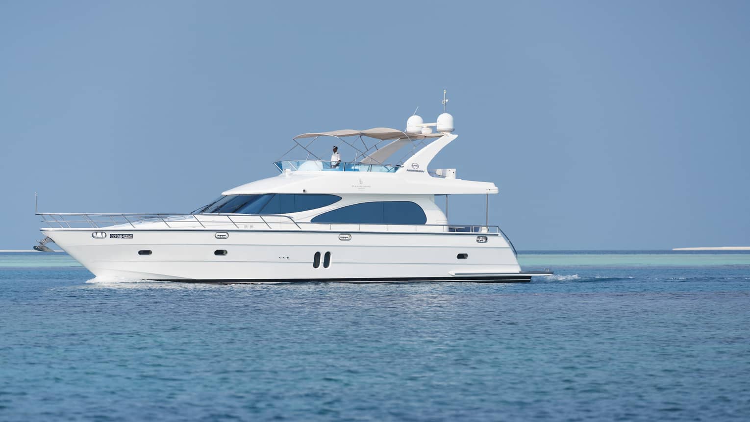 Small white private luxury yacht sailing on ocean