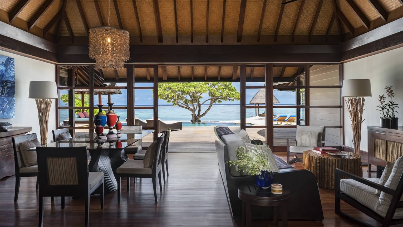 Wood-floored living room, opening up to the beach, of a Two-Bedroom Royal Beach Villa