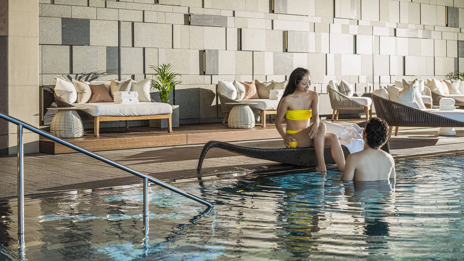 Couple relaxes poolside at the indoor pool