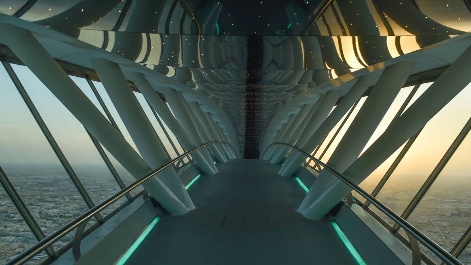 Looking down through white Sky Bridge, city far below