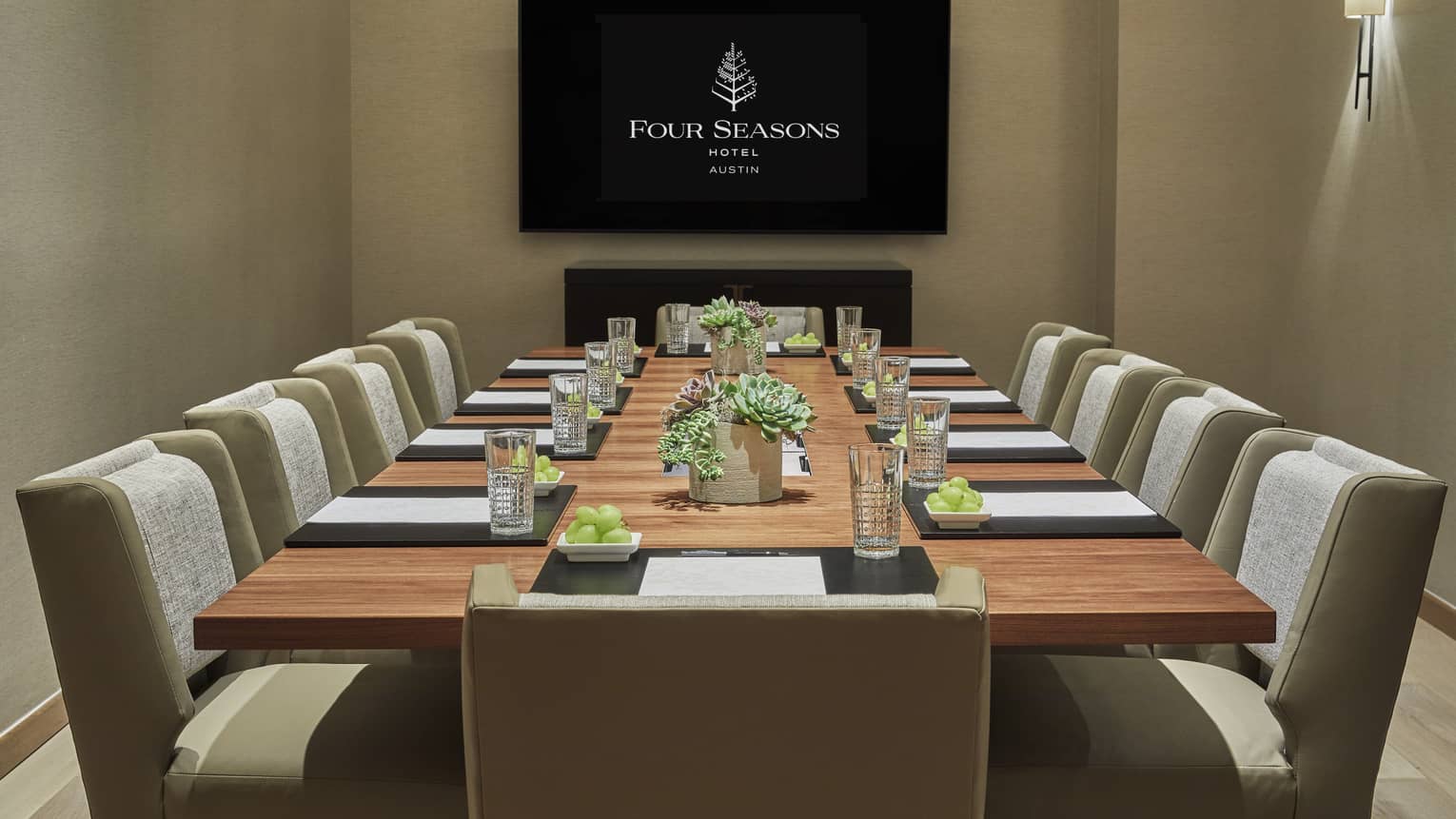 Bouldin Creek meeting room with long boardroom table, screen with Four Seasons logo