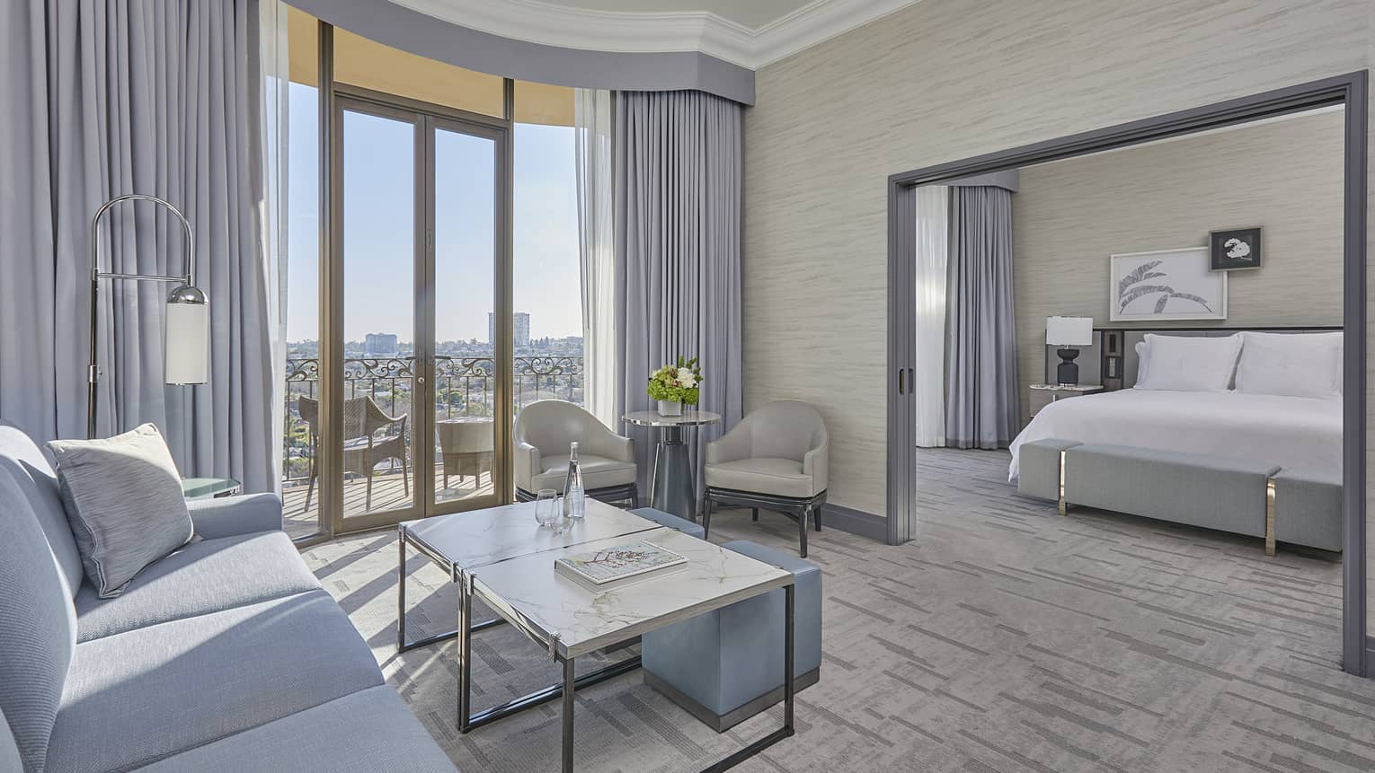 Hotel suite living room with balcony and separate bedroom