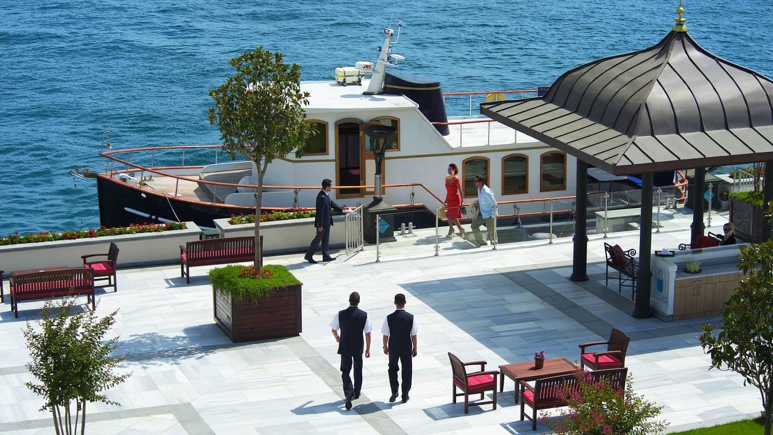 Looking down at people on dock by private cruise yacht 