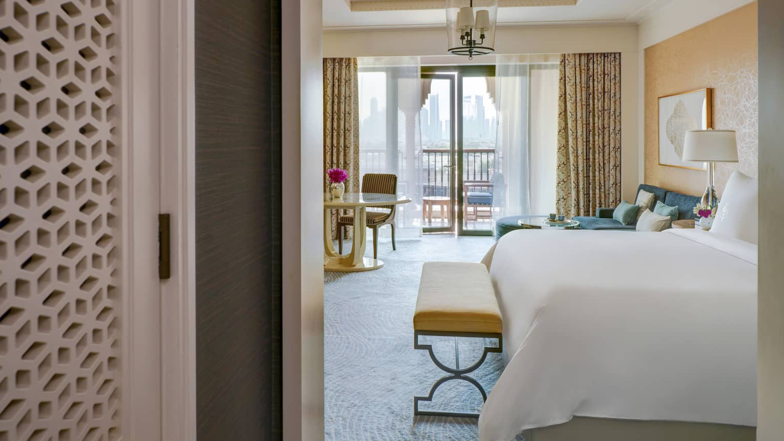 Entryway into a bedroom with king bed and walk-out balcony