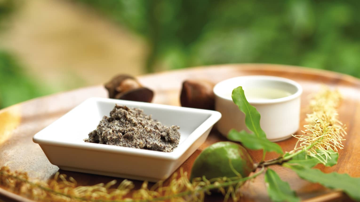 Ground nut butter, whole lime, small dishes on spa tray