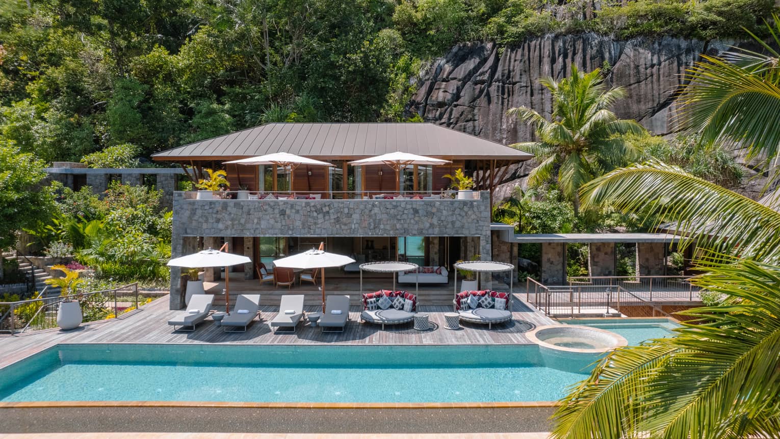 Exterior of three-bedroom beach suite in Seychelles, with large private pool and pool deck