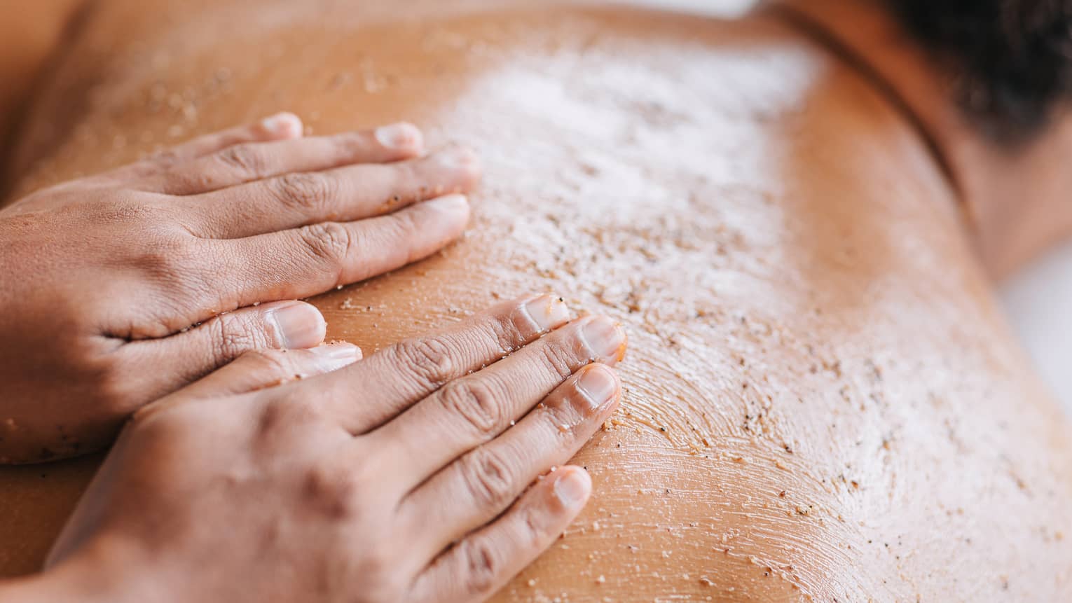 Massaging with sand on back