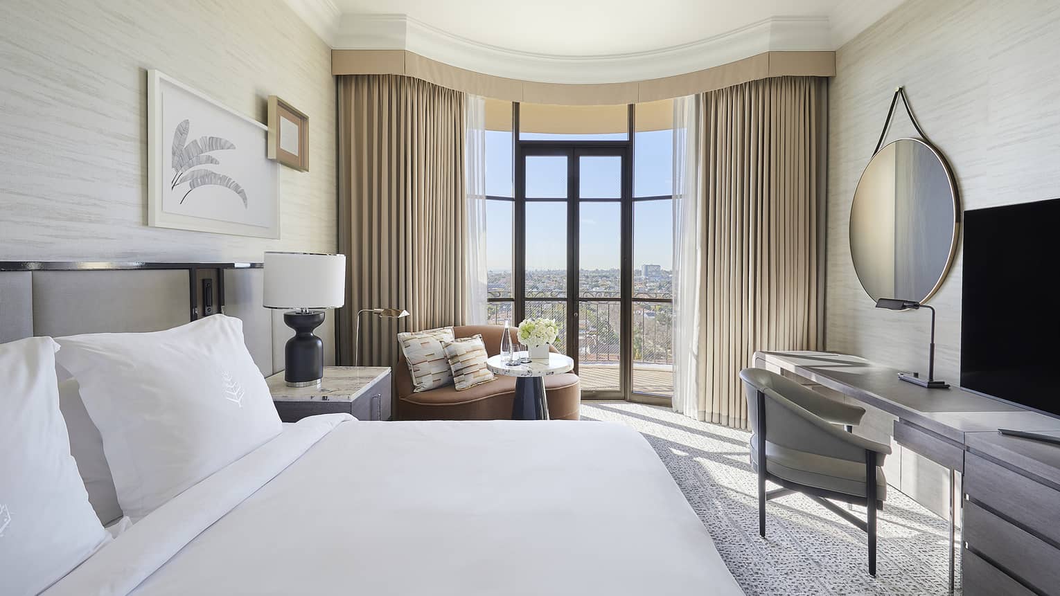 Hotel room with king bed, sitting area and desk