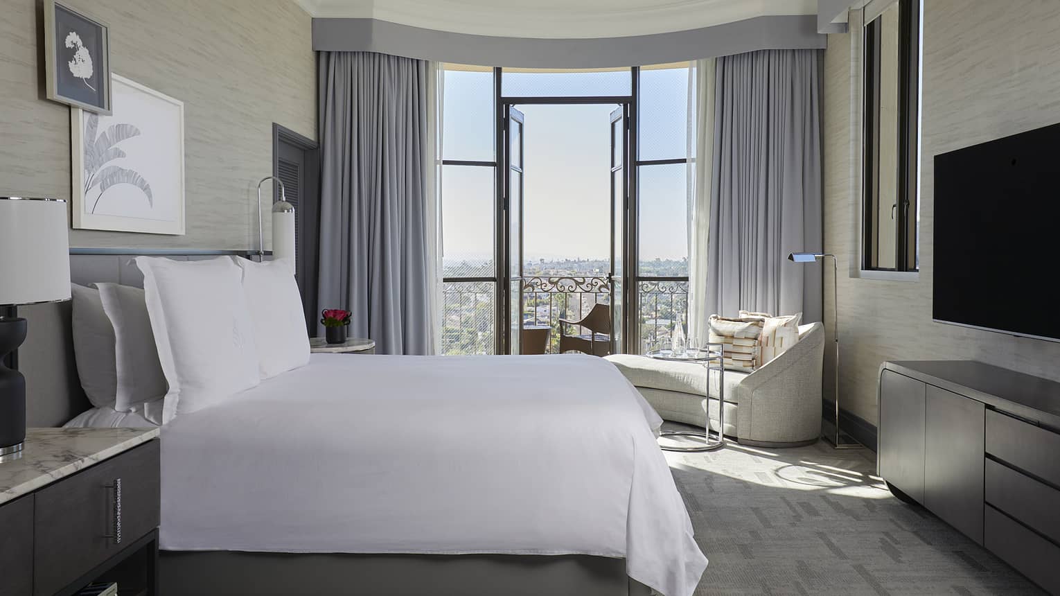 Bedroom with king bed and city-view balcony