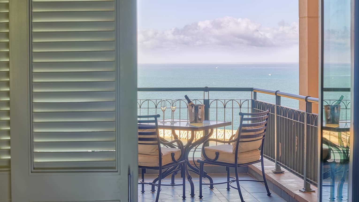 Four Seasons Suite veranda with two-seater table, ocean views