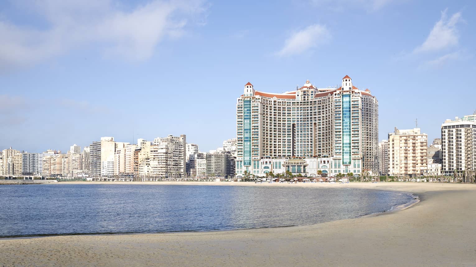 Hotel exterior against backdrop of the city on the beach