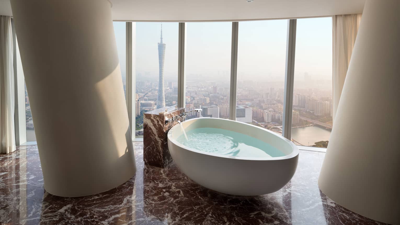 Premier King Canton Tower View Room large soaking tub in front of floor-to-ceiling windows with natural light