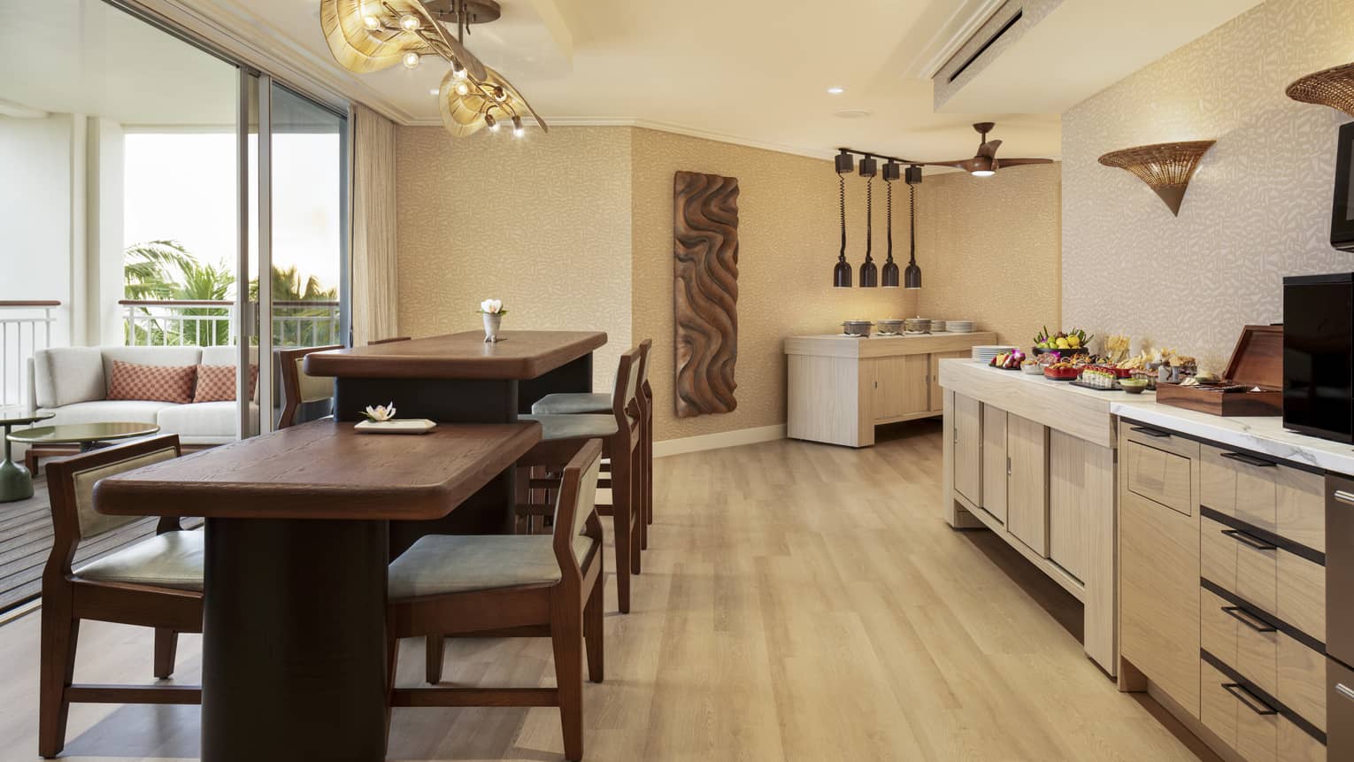 Self-serve counter and two dining tables of different heights in an executive club lounge at resort
