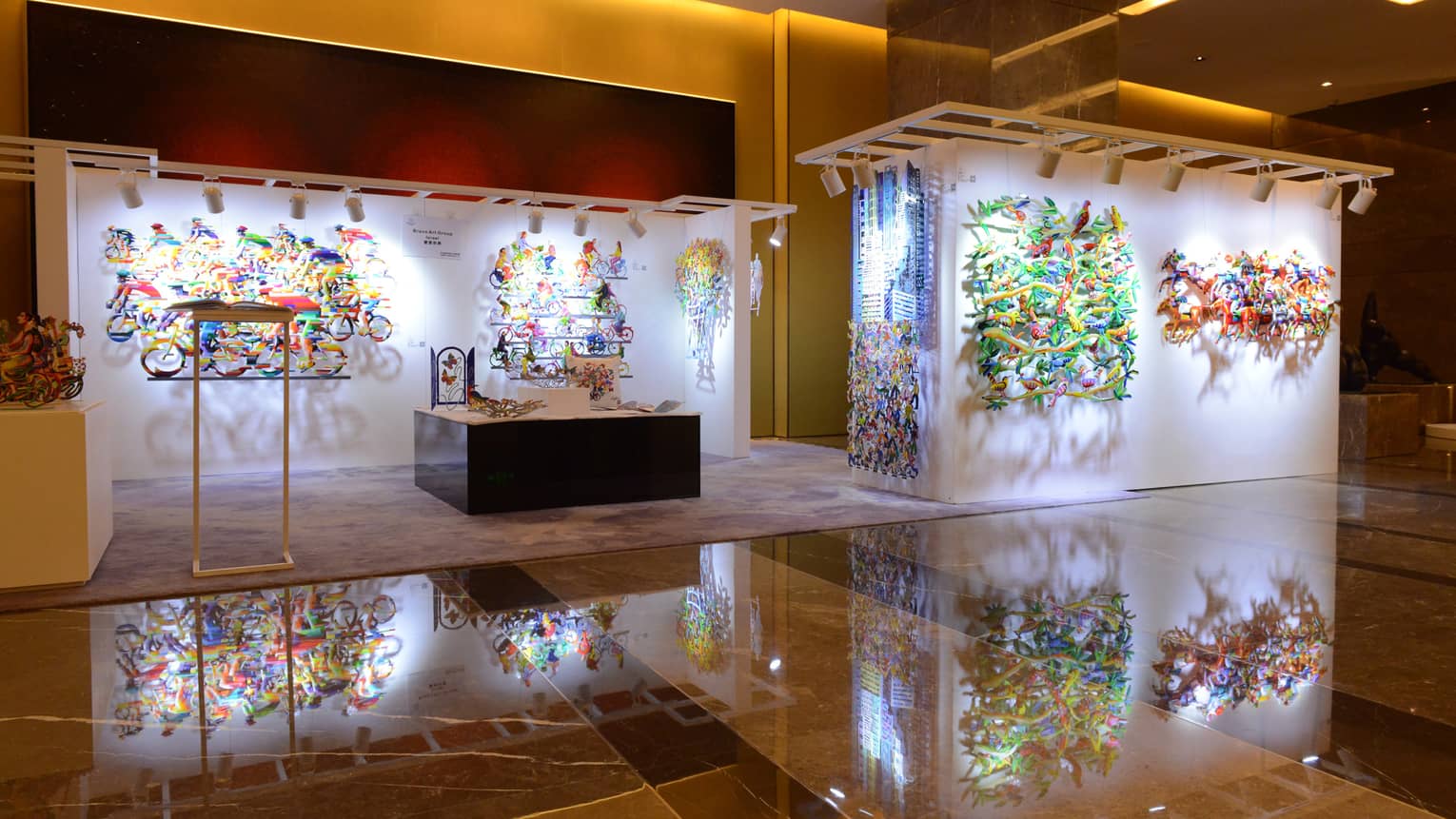 Colourful art of cyclists, birds hanging on gallery walls 