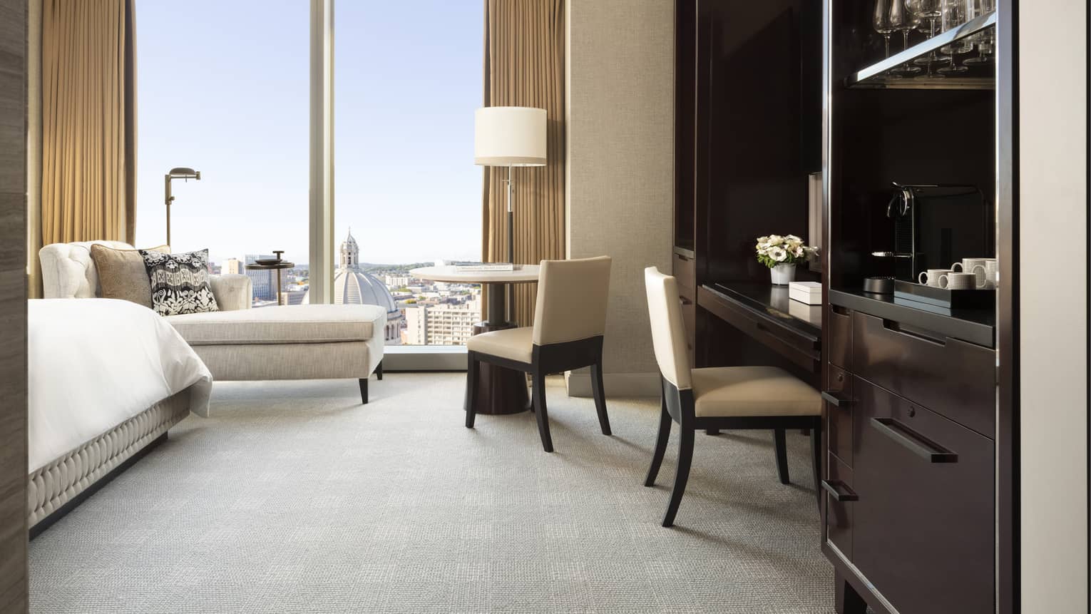 Built-in desk area in a guest room, with floor to ceiling windows overlooking Boston's Back Bay