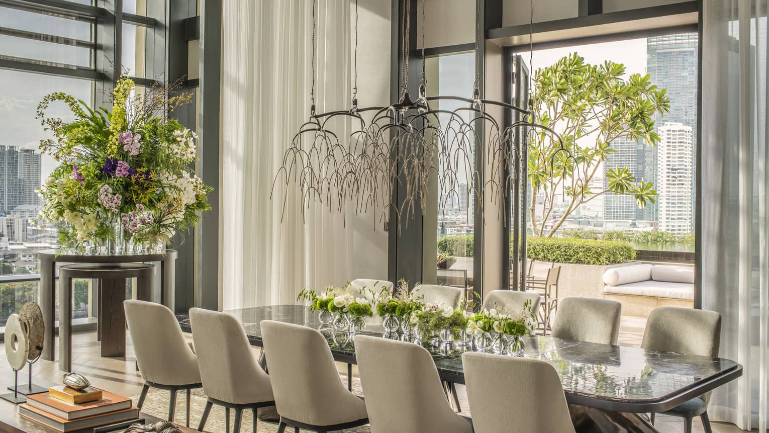 Dining table with 10 chairs, opening to a city-view terrace