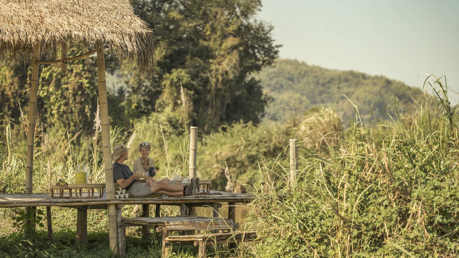 Couple enjoys a camp picnic in the Thai wilderness