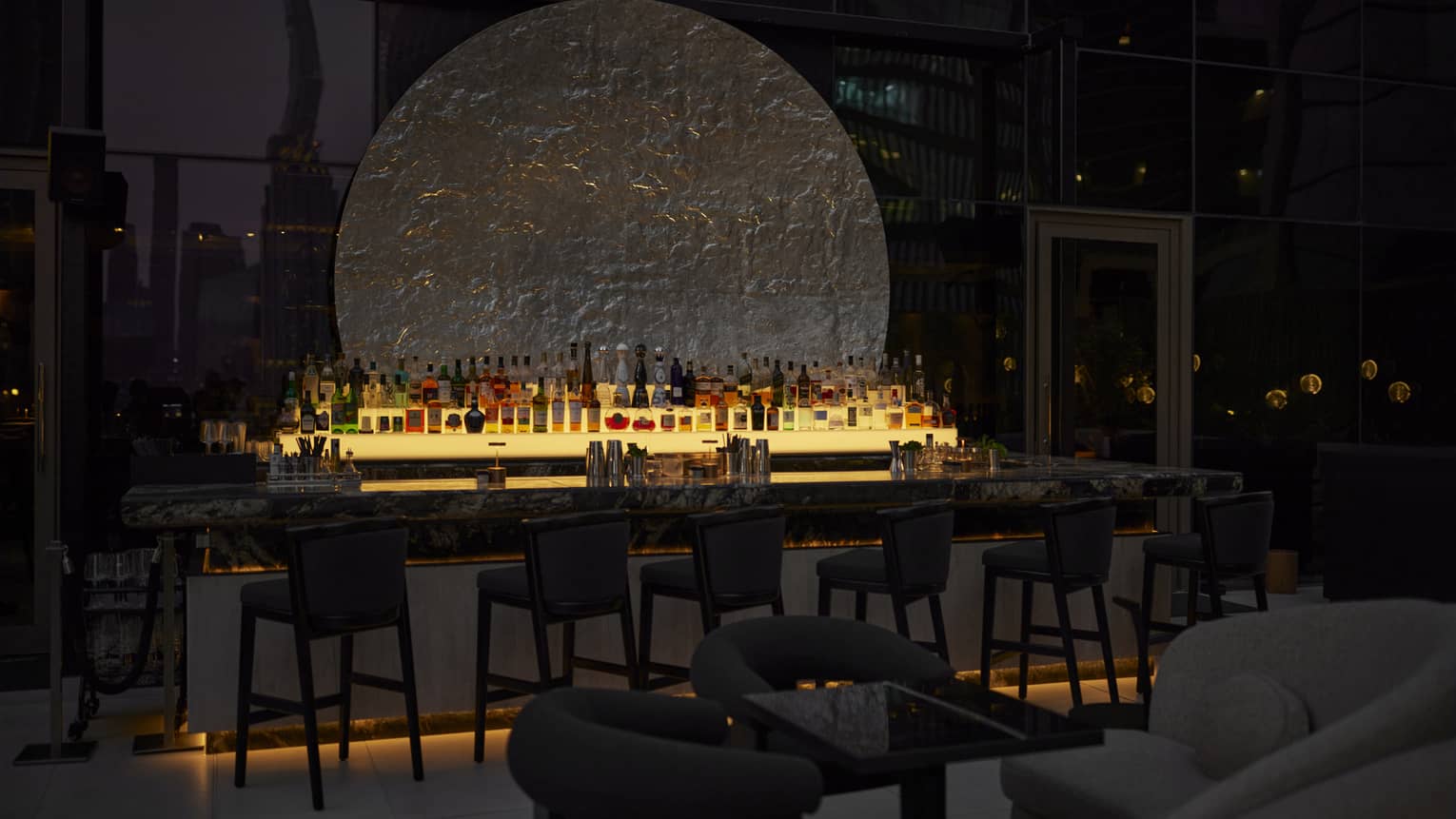 Illuminated bar in dark outdoor lounge