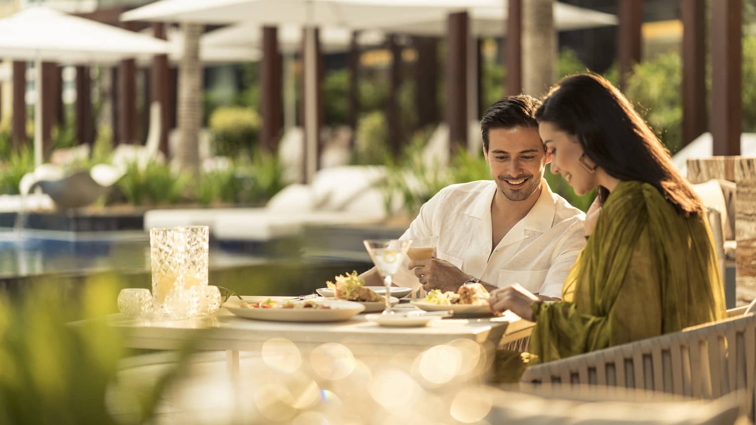 A couple eats together at Pool Bar and Grill