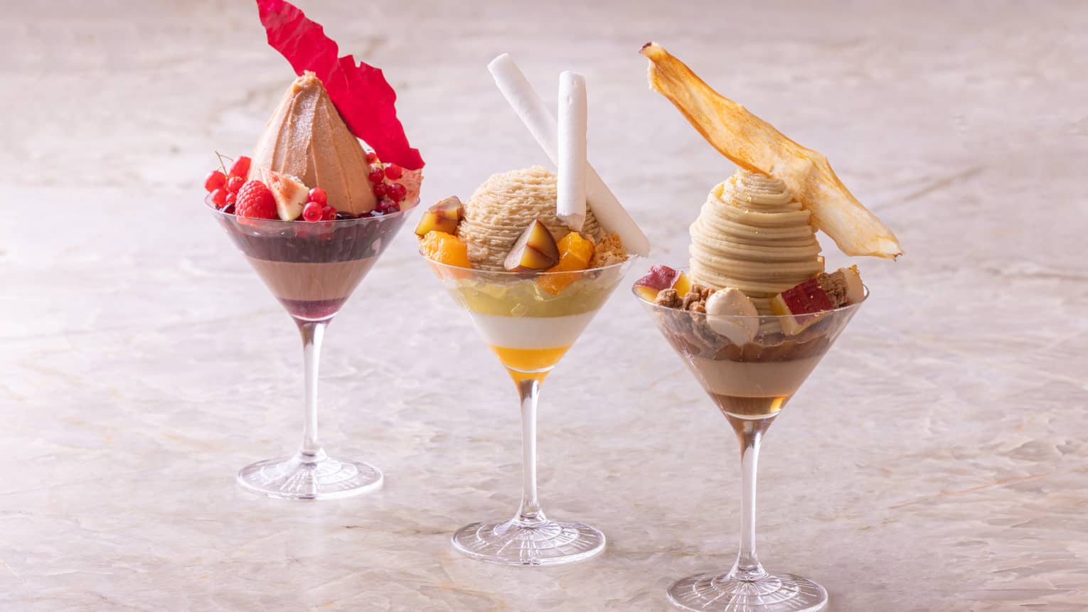Trio of seasonal parfaits in stemmed glasses