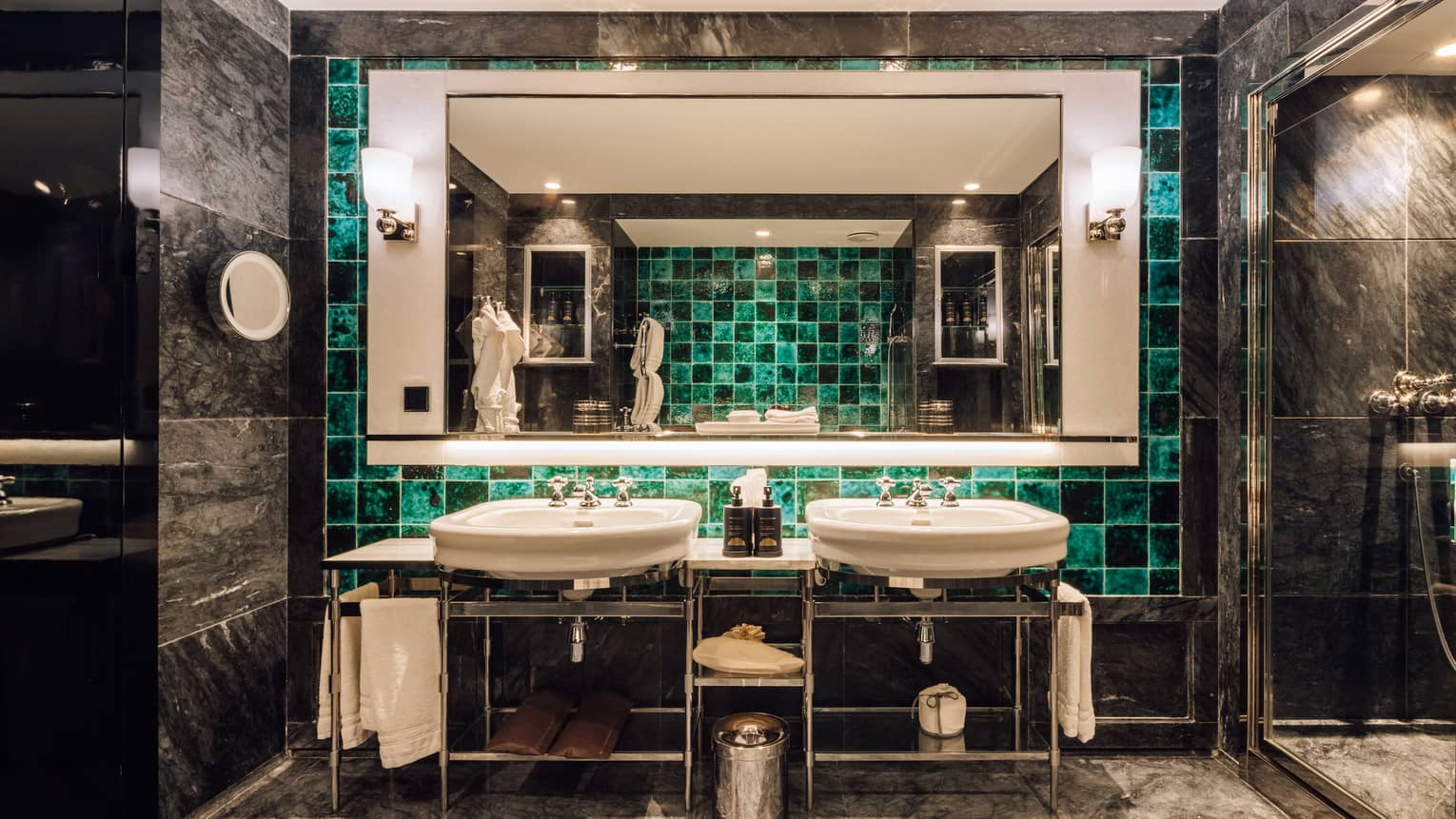 Dark marble bathroom with two sinks, turquoise tile and walk-in shower