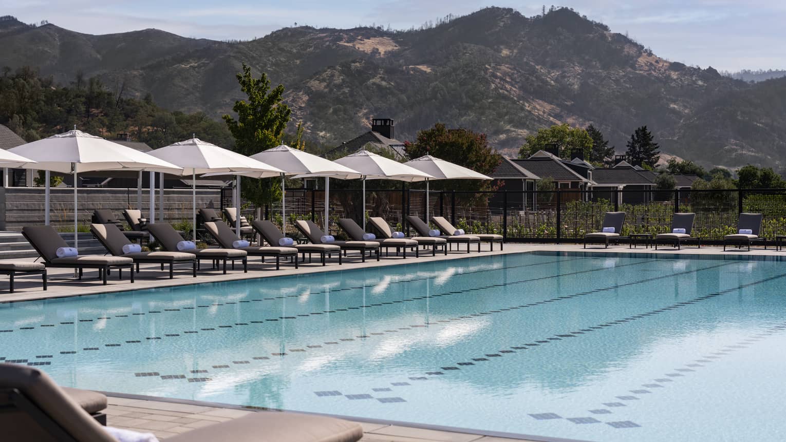 Olympic-sized swimming pool with mountains in the distance