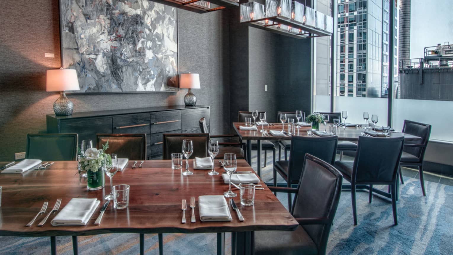 Goldfinch Tavern dining room with rustic wood table, grey chairs and decor