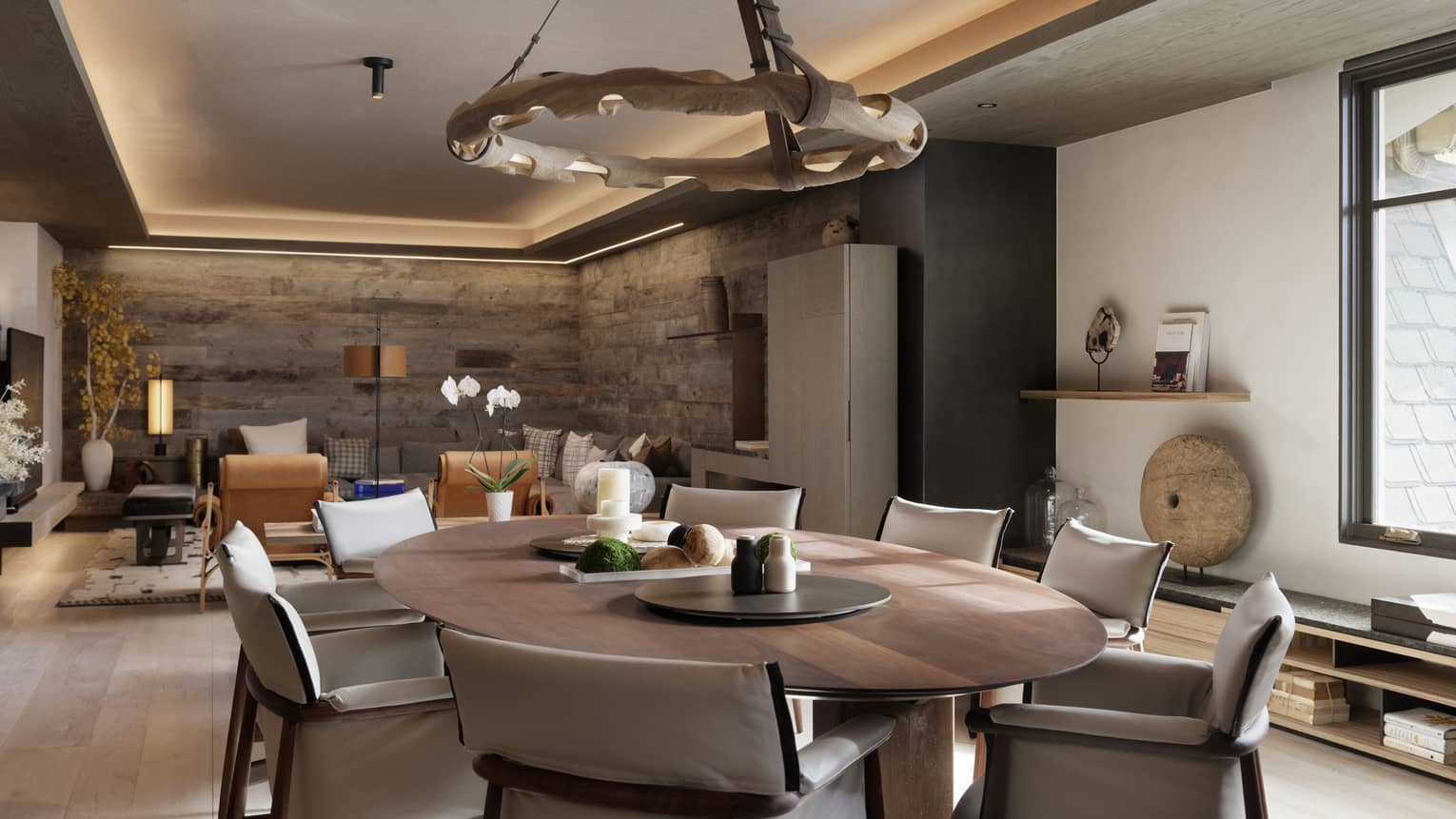 Contemporary dining room with oval wooden table and eight upholstered chairs
