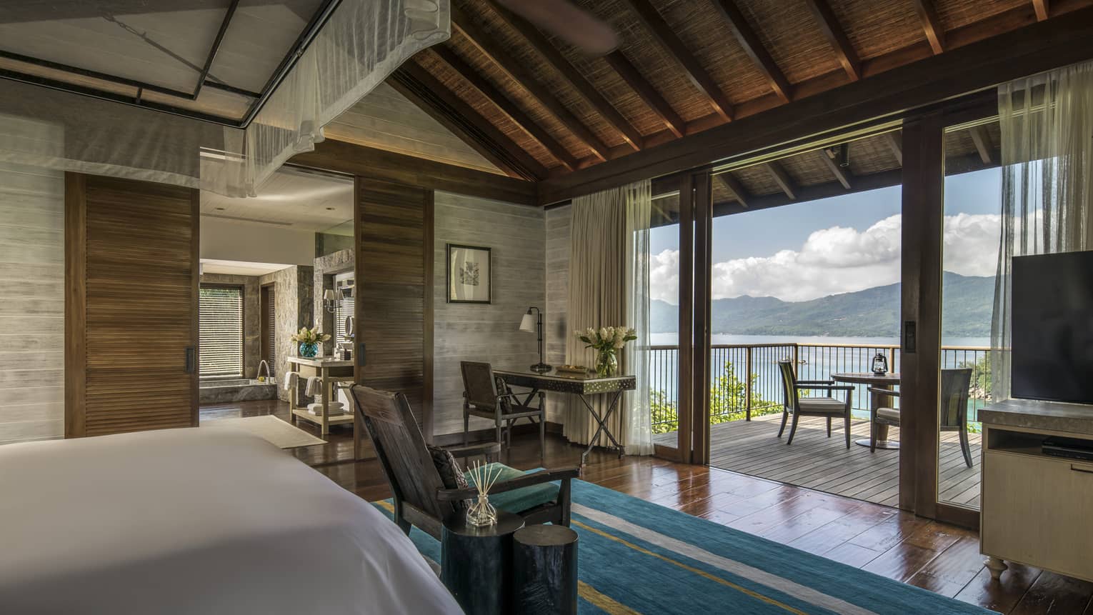 Three-Bedroom Residence Villa bedroom end of bed, blue carpet in front of patio door