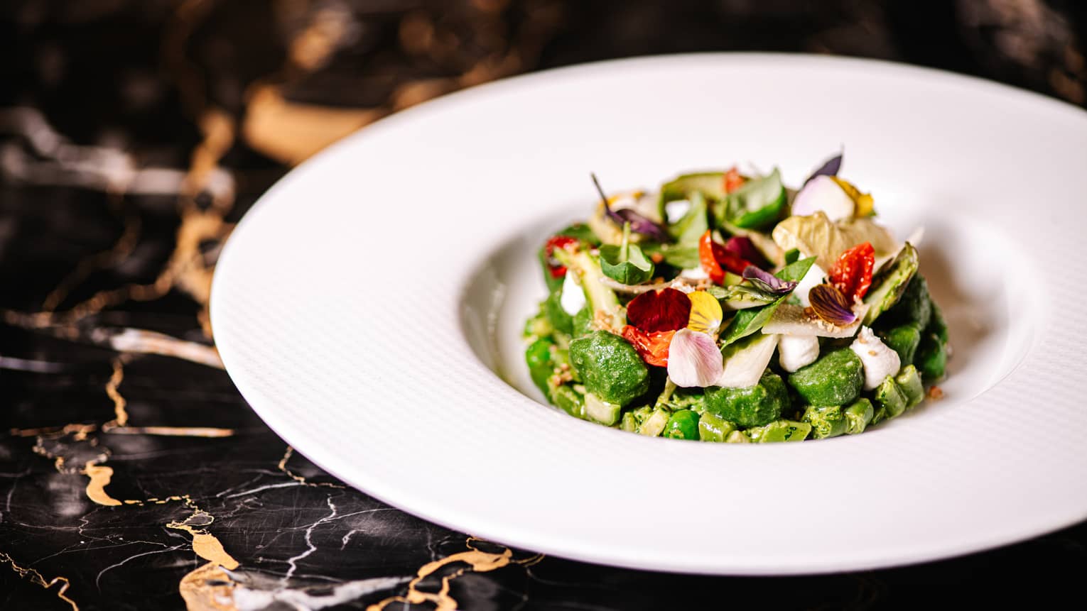 Bowl of Sweet Potato Gnocchi with Borage, Spring Vegetables and Ricotta