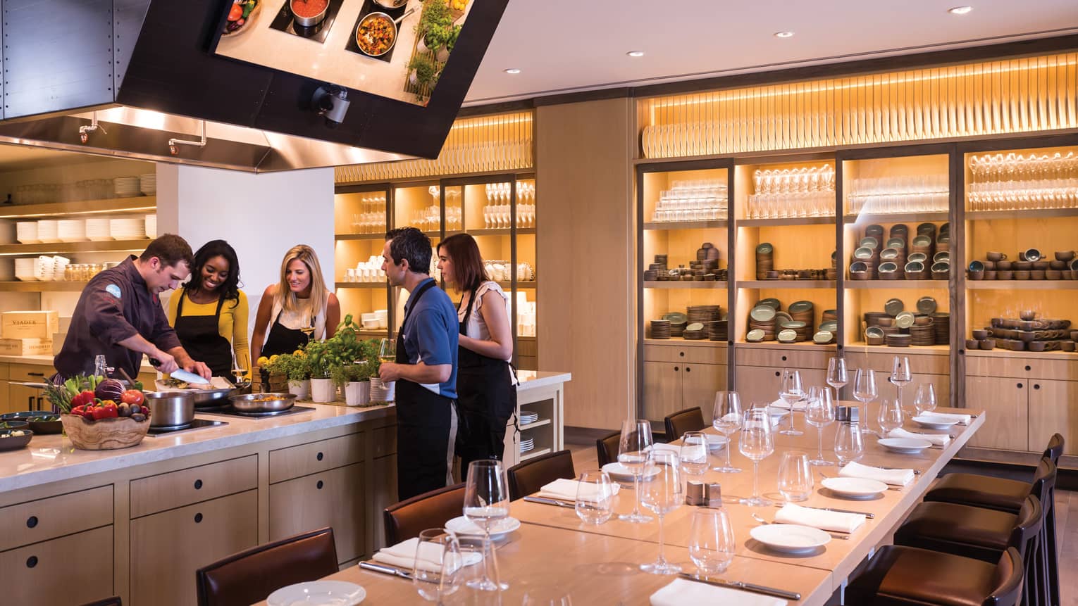 Ravello Kitchen private dining table, group gathered around counter, chef during cooking demonstration