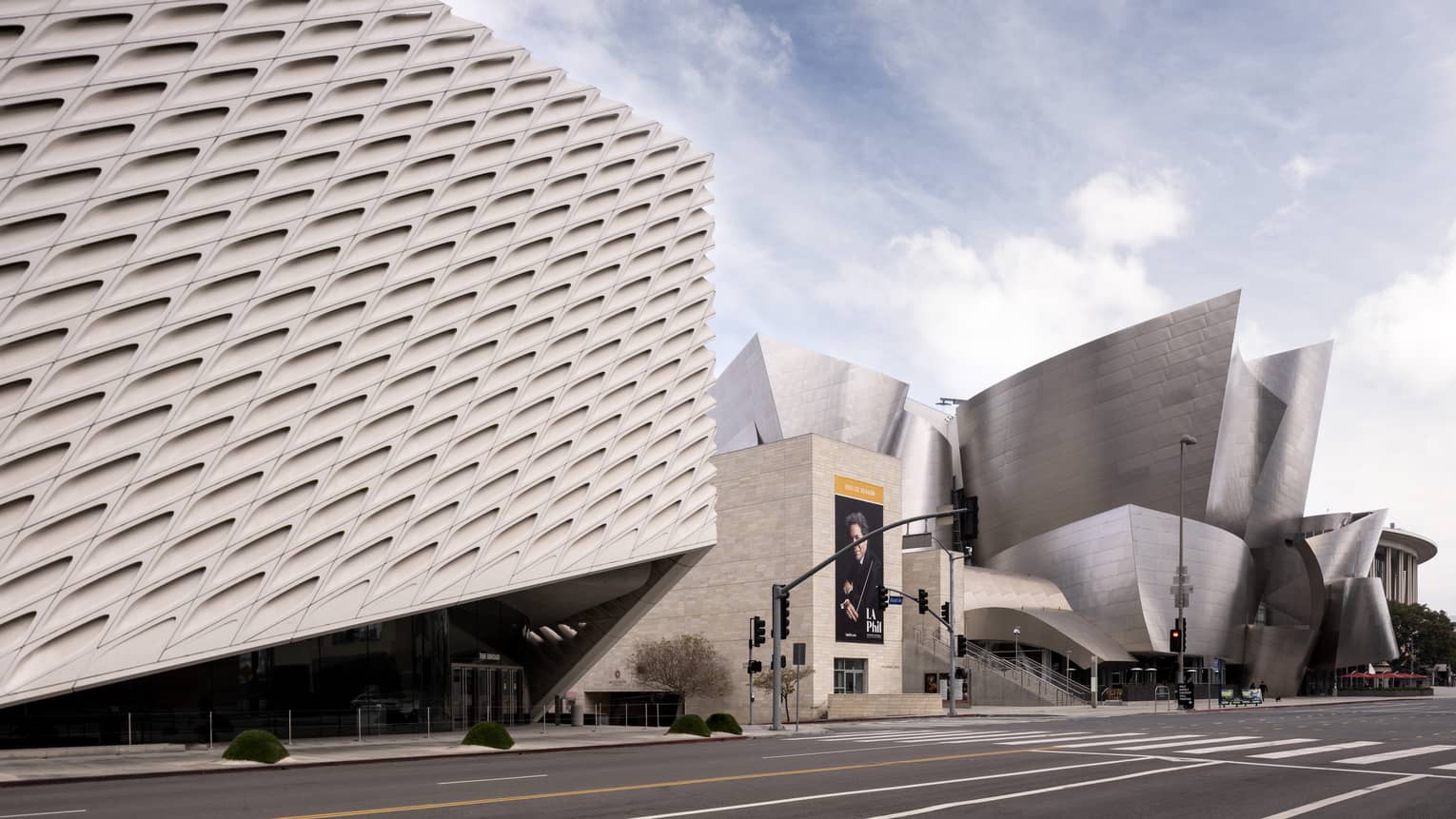 A large concrete building next to a large metal building.